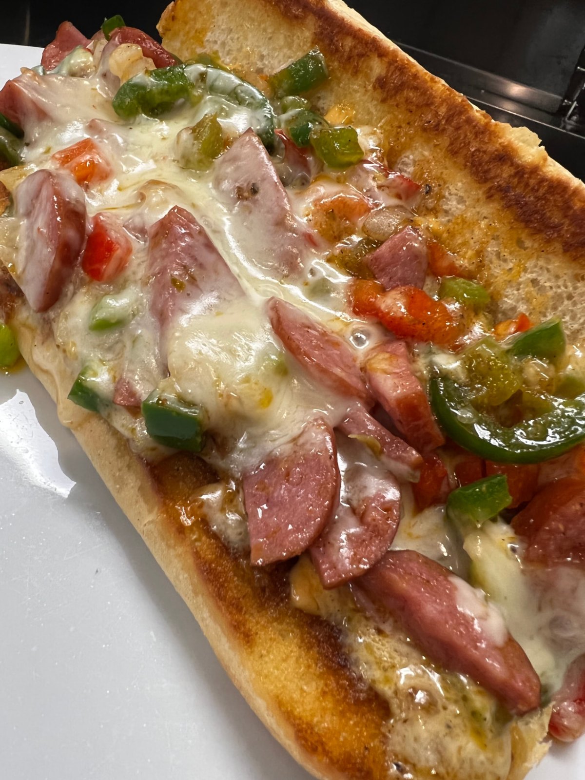Smoked kielbasa hoagie with peppers, onions and pepper jack