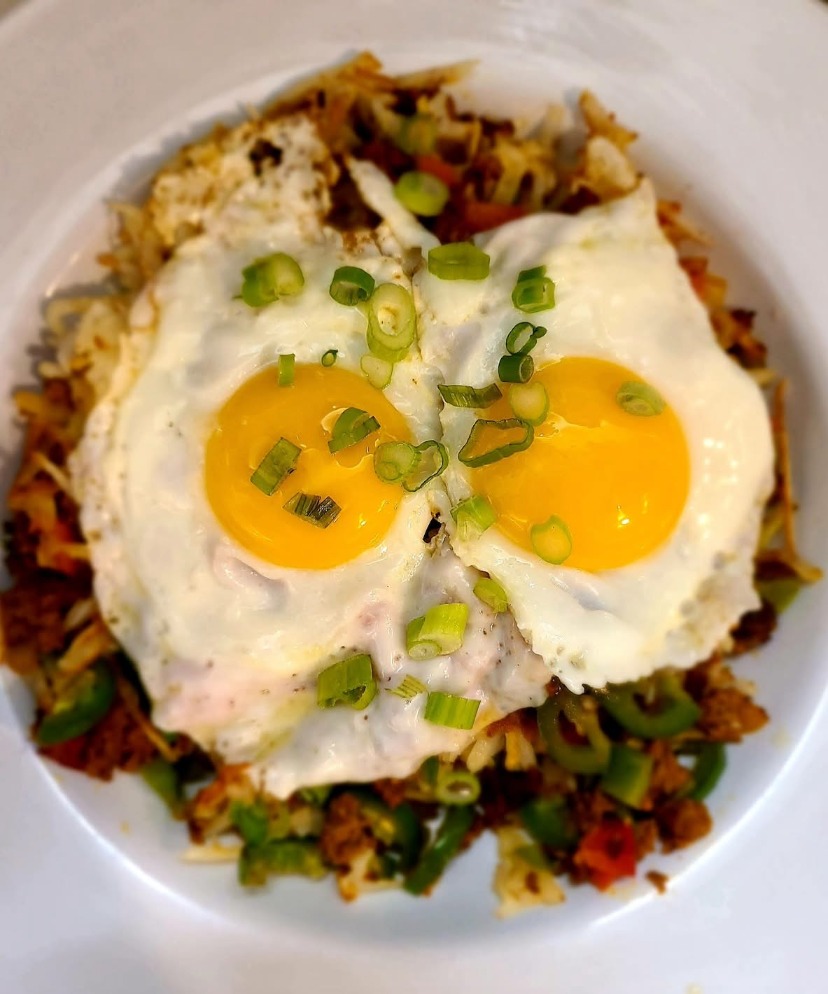 Loaded skillet with home fries, peppers and eggs
