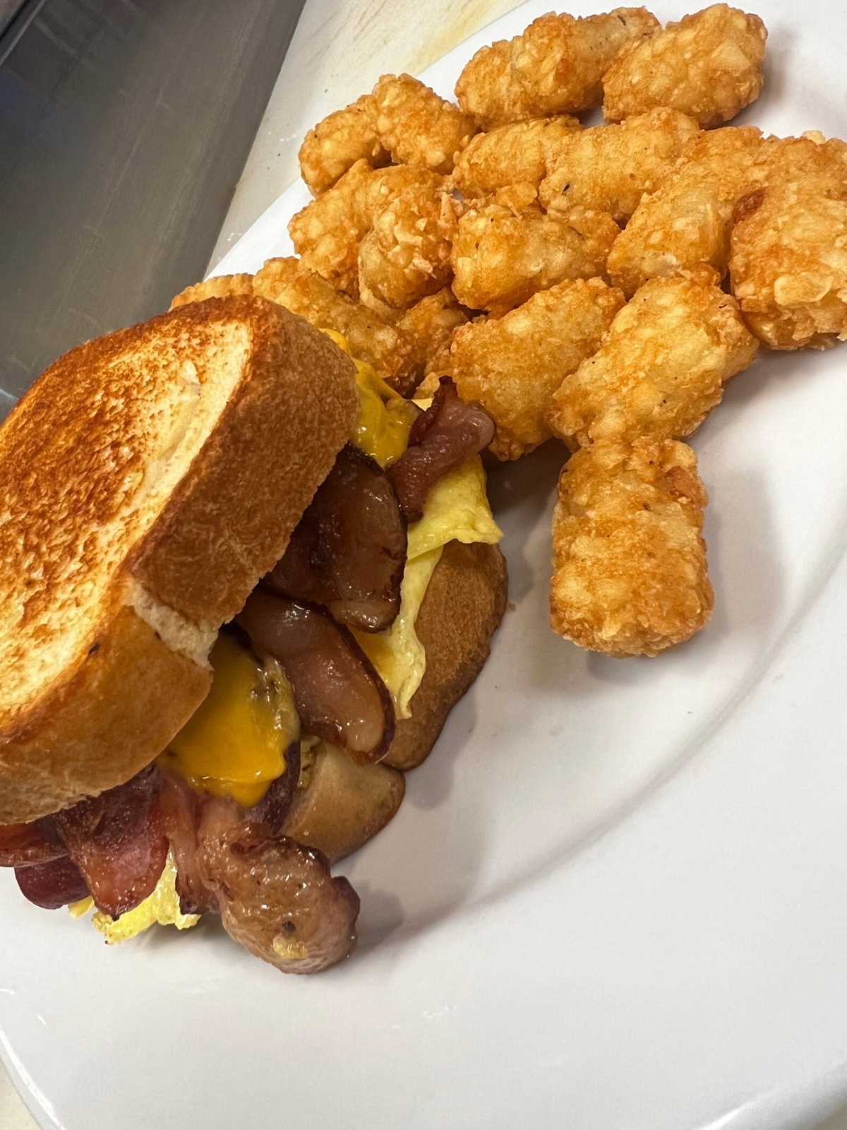 Breakfast griller on a grilled croissant with eggs and cheese
