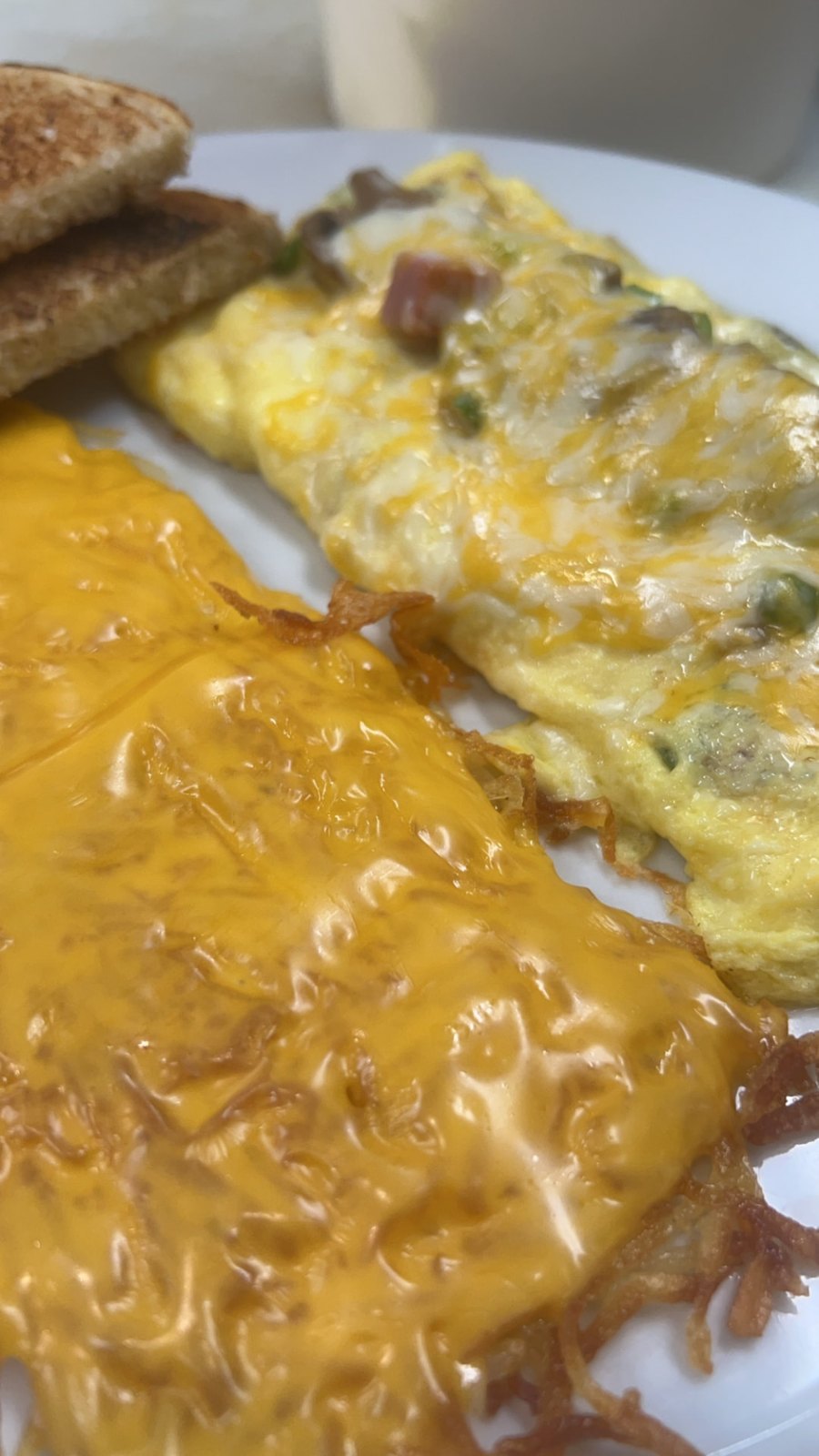 Ham and cheese omelette with hash browns and toast