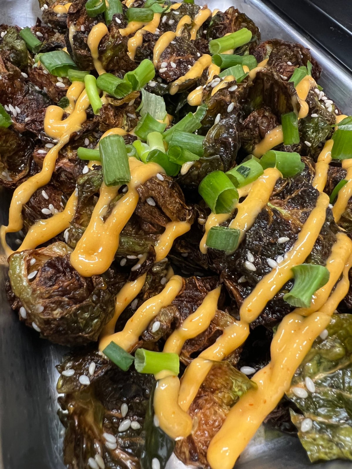 Crispy brussel sprouts with Asian sauce and sesame seeds