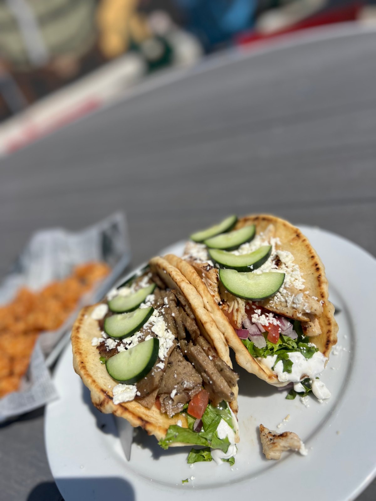 Gyro on a toasted pita with lettuce, tomato, red onion and tzatziki